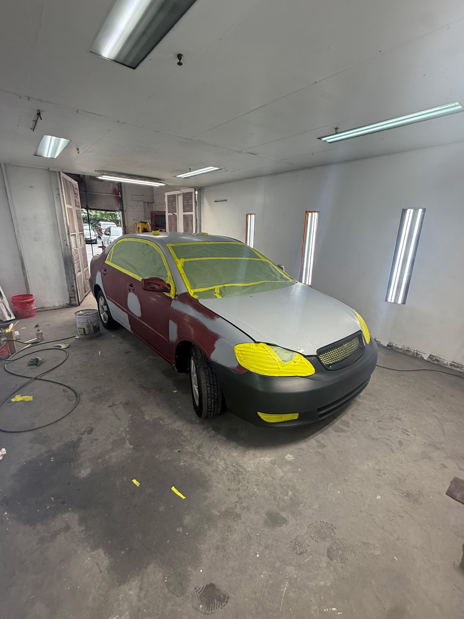 Sedan masked and primed in the Complete Car Cure paint booth
